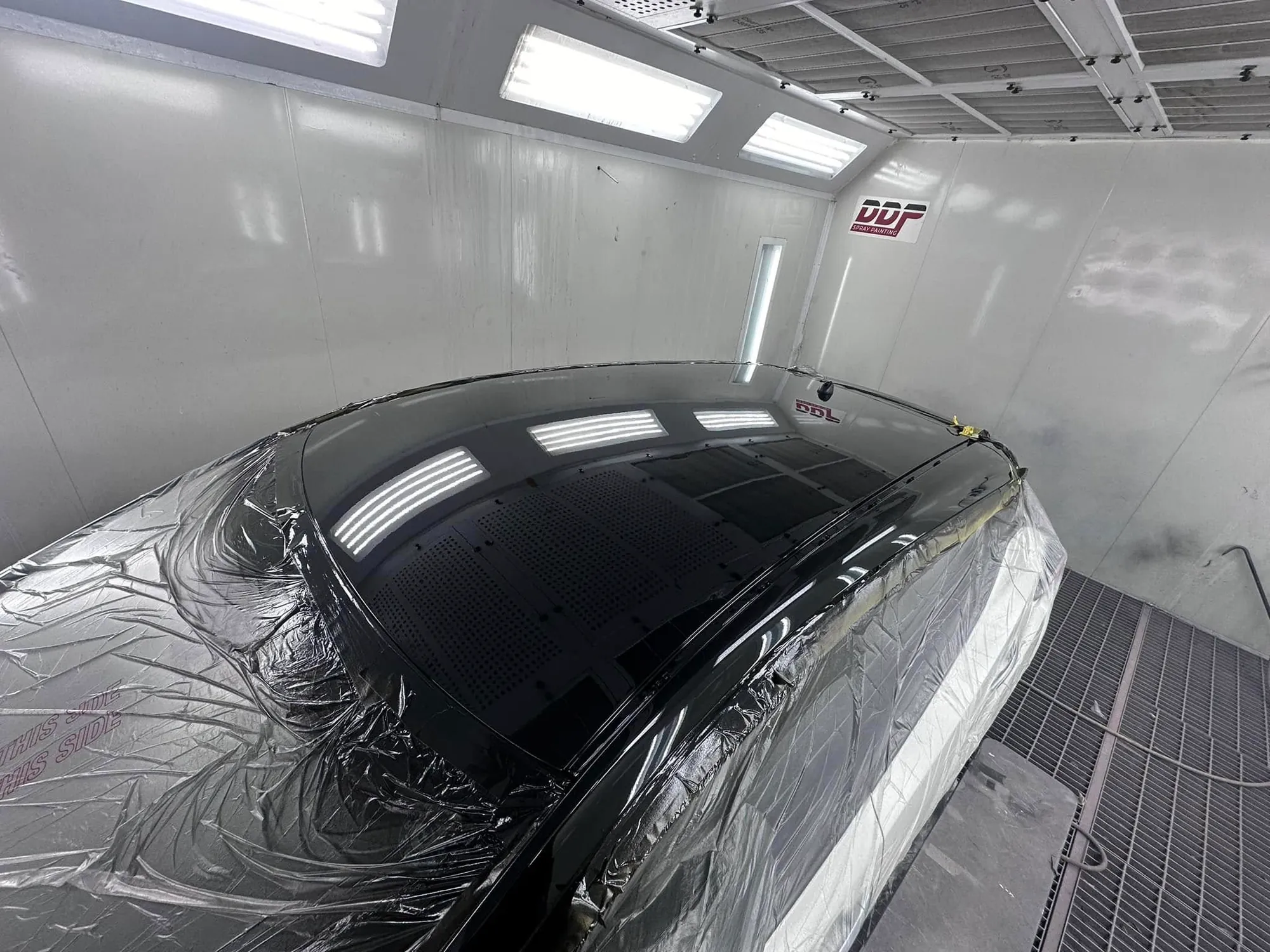 Coupe roof freshly painted gloss black in the booth