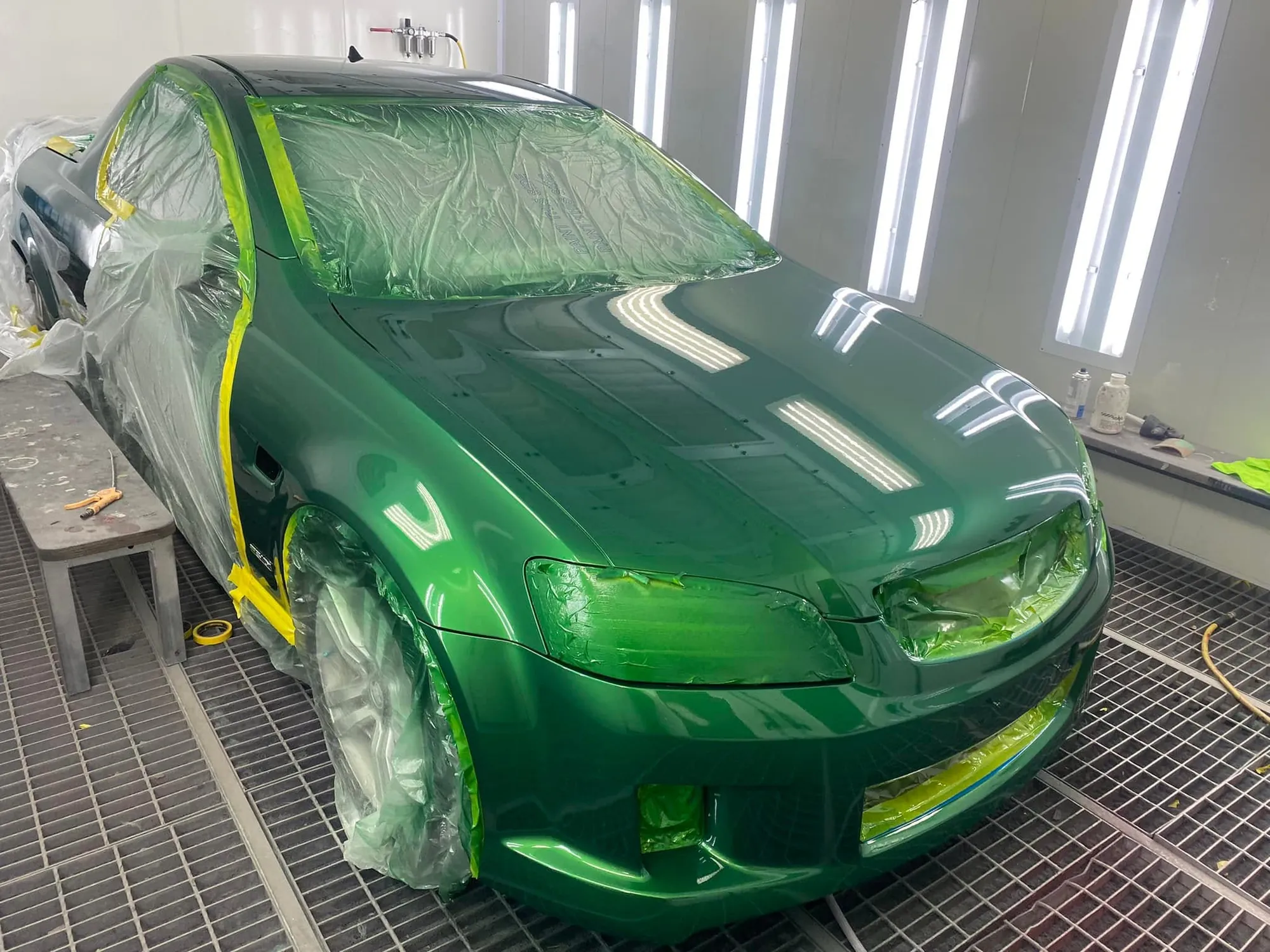 Holden Commodore masked up in the booth during a green respray