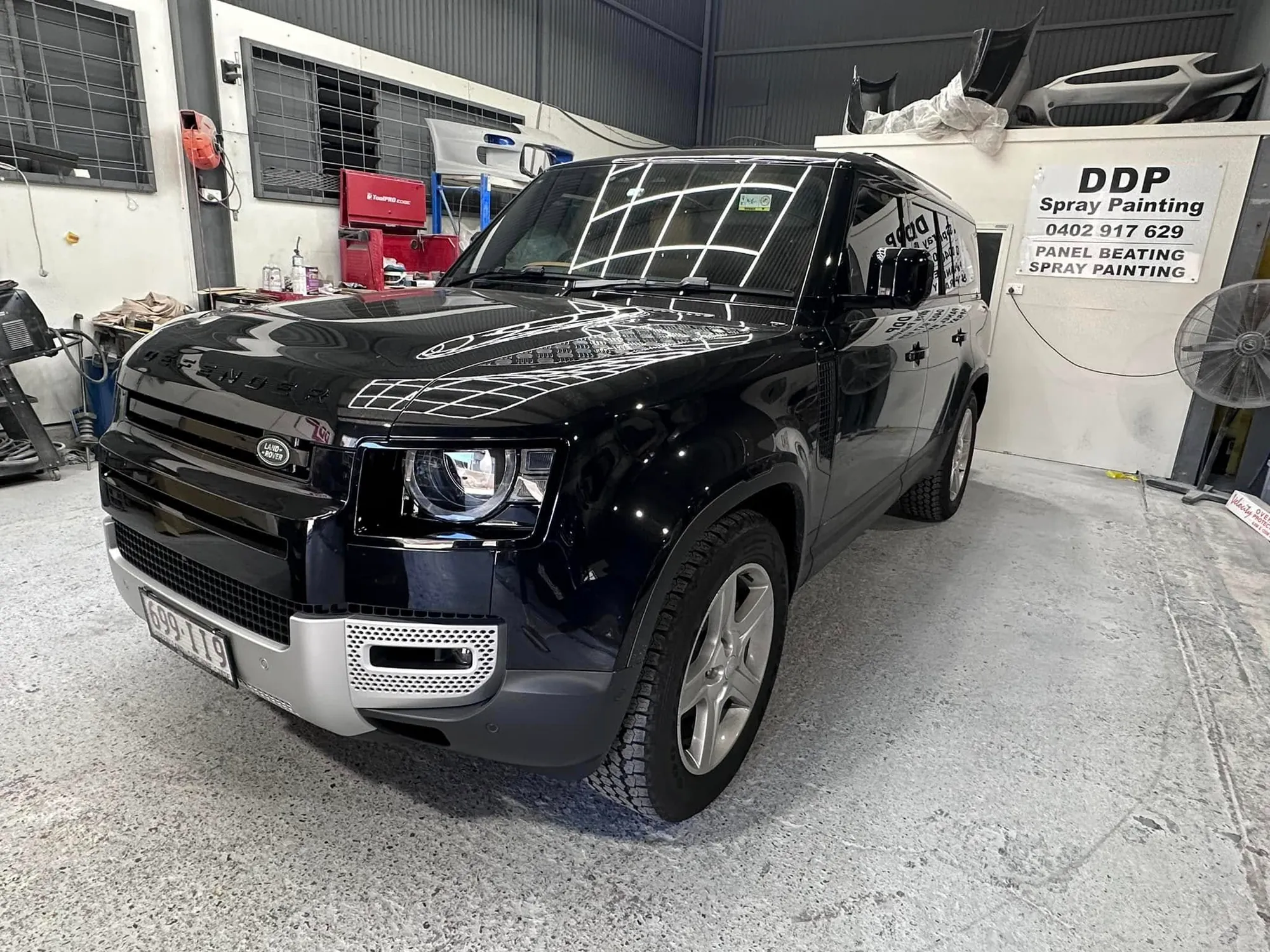 Black Land Rover Defender after a front-end respray