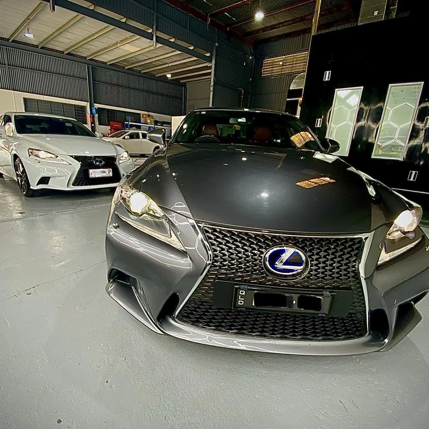 Two Lexus IS sedans in the DDP Spray Painting workshop