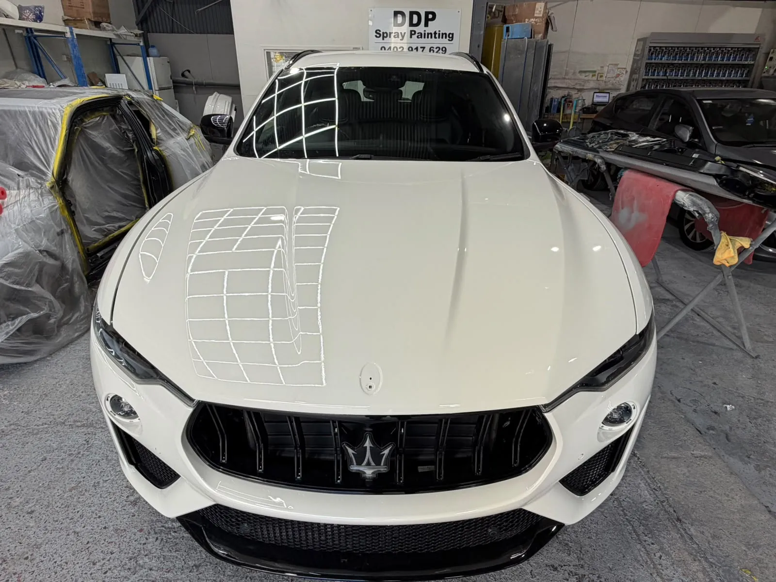 Maserati Levante bonnet guide-coated and sanded during paint prep at DDP Spray Painting