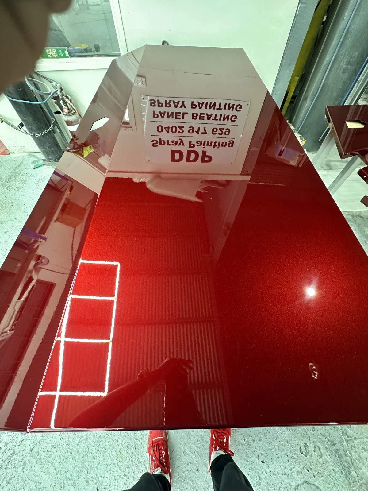 Deep gloss red bonnet reflecting the DDP Spray Painting booth after a respray
