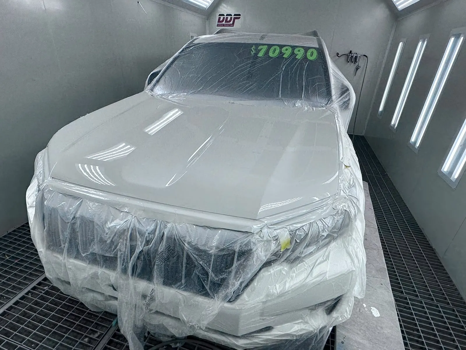White SUV masked and prepped for a respray in the DDP spray booth